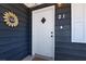 Welcoming front door with sunflower decor and modern doorbell on a home with gray siding at 21 Laswell St, Henderson, NV 89015
