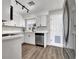 Modern kitchen with white cabinets, stainless steel appliances, and updated fixtures at 21 Laswell St, Henderson, NV 89015