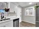 Updated kitchen boasts stainless steel dishwasher and sink, accompanied by ample natural light at 21 Laswell St, Henderson, NV 89015
