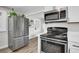 Updated kitchen featuring stainless steel fridge, microwave and gas stove at 21 Laswell St, Henderson, NV 89015