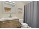 Updated bathroom with a modern vanity, stylish mirror, and a shower with a gray curtain at 220 Mission Newport Ln # 105, Las Vegas, NV 89107