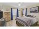 Comfortable bedroom features a large bed, wood-look floors, and soft natural light at 220 Mission Newport Ln # 105, Las Vegas, NV 89107