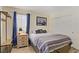 Comfortable bedroom featuring wood floors, a queen-size bed, and an enclosed closet at 220 Mission Newport Ln # 105, Las Vegas, NV 89107
