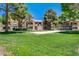 Well-maintained apartment complex with landscaped lawns and mature trees at 220 Mission Newport Ln # 105, Las Vegas, NV 89107