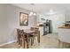 Open dining space connects the kitchen and living area, featuring a wood table set and stylish decor at 220 Mission Newport Ln # 105, Las Vegas, NV 89107