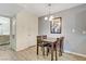 Charming dining area with wood-look flooring, a modern light fixture, and a four-chair table set at 220 Mission Newport Ln # 105, Las Vegas, NV 89107