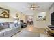 Inviting living area with wood-look floors, comfortable seating, and an open view to the kitchen at 220 Mission Newport Ln # 105, Las Vegas, NV 89107