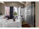 This bathroom showcases a glass-enclosed shower and a separate tub, enhanced by natural light at 2500 Cortina Ave, Henderson, NV 89074