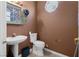 Cozy half bath with dark walls, tiled floors, and a window at 2500 Cortina Ave, Henderson, NV 89074