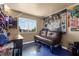 Unique bedroom features blue flooring, a futon, and a large picture window at 2500 Cortina Ave, Henderson, NV 89074