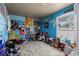 Eclectic bedroom with bright blue walls and lots of stuff; offers a unique, personalized space at 2500 Cortina Ave, Henderson, NV 89074