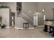 Inviting entryway featuring neutral walls, tile floors, a staircase, and ample space for decor at 2500 Cortina Ave, Henderson, NV 89074