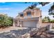 Charming two-story home shows a well-maintained yard and driveway, with desert landscaping at 2500 Cortina Ave, Henderson, NV 89074