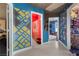 Colorful hallway with creative wall designs, leading to different rooms, showcasing unique decor at 2500 Cortina Ave, Henderson, NV 89074