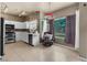 Eat-in kitchen features white cabinets, tile floors, stainless steel appliances, and abundant natural light at 2500 Cortina Ave, Henderson, NV 89074