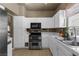 This kitchen shows white cabinets, stainless steel oven/stove, white counters and tile backsplash at 2500 Cortina Ave, Henderson, NV 89074