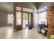 Bright living room with neutral walls, tiled floors, and large windows providing natural light at 2500 Cortina Ave, Henderson, NV 89074
