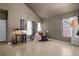 Bright living room with neutral walls, tiled floors, and large windows providing natural light at 2500 Cortina Ave, Henderson, NV 89074