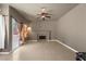 Open-plan living room featuring tile flooring, a ceiling fan, access to the backyard and a cozy fireplace at 2500 Cortina Ave, Henderson, NV 89074