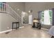 Bright living room with neutral walls, tiled floors, and large windows providing natural light at 2500 Cortina Ave, Henderson, NV 89074