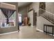 Bright living room with neutral walls, tiled floors, and large windows providing natural light at 2500 Cortina Ave, Henderson, NV 89074