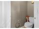 Small half-bath features a basic toilet and damage to the surrounding wall, indicating needed repairs at 2500 Cortina Ave, Henderson, NV 89074