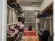 Walk-in closet with hanging clothes and storage shelves at 2500 Cortina Ave, Henderson, NV 89074
