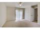 Light-filled bedroom with plush carpet and sliding glass doors to outdoor patio at 2801 N Rainbow Blvd # 273, Las Vegas, NV 89108