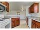 Functional kitchen with white appliances, dark wood cabinets, and an open view into the living area at 2801 N Rainbow Blvd # 273, Las Vegas, NV 89108
