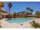 Community pool with palm trees and lounge chairs, surrounded by lush landscaping at 2801 N Rainbow Blvd # 273, Las Vegas, NV 89108