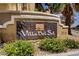 Villa Del Sol community sign with lush yellow flowers and a well-maintained landscape at 2801 N Rainbow Blvd # 273, Las Vegas, NV 89108