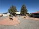 Large backyard with trees, desert landscaping, a shed, and a patio area at 3031 Pebble Beach Ave, Pahrump, NV 89048