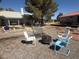 Inviting backyard featuring gravel and a patio with seating around a fire pit at 3031 Pebble Beach Ave, Pahrump, NV 89048