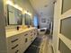 Bathroom featuring double sinks, a soaking tub, and decorative artwork on the walls at 3031 Pebble Beach Ave, Pahrump, NV 89048