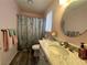 Bathroom featuring wood floors, marble countertop, and shower with decorative curtain at 3031 Pebble Beach Ave, Pahrump, NV 89048