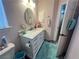 Bathroom featuring marble countertop, oval mirror, and blue rug on wood-like flooring at 3031 Pebble Beach Ave, Pahrump, NV 89048