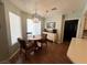 Charming dining area features wood floors, stylish chandelier, and a window for natural light at 3031 Pebble Beach Ave, Pahrump, NV 89048