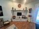 Living room showcasing the fireplace with stone accents and hardwood floors at 3031 Pebble Beach Ave, Pahrump, NV 89048