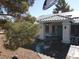Charming covered front porch and entrance with decorative pillars, solar panels and desert landscaping at 3031 Pebble Beach Ave, Pahrump, NV 89048