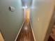 Long hallway with hardwood flooring and light green walls leading to multiple rooms at 3031 Pebble Beach Ave, Pahrump, NV 89048