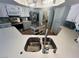 Kitchen boasts expansive countertops, stainless steel appliances, and a view into adjacent laundry room at 3031 Pebble Beach Ave, Pahrump, NV 89048