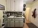 The laundry room features updated cabinets, a stainless steel sink, and decorative backsplash at 3031 Pebble Beach Ave, Pahrump, NV 89048