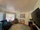 Cozy living room featuring a large window with natural light, comfortable furniture, and stylish decor at 3031 Pebble Beach Ave, Pahrump, NV 89048