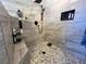 Modern walk-in shower with a rain shower head and a mosaic tile floor at 3031 Pebble Beach Ave, Pahrump, NV 89048