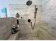 Modern walk-in shower with a rain shower head and mosaic tile floor at 3031 Pebble Beach Ave, Pahrump, NV 89048