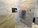Walk-in shower showcasing modern tile, fixtures, and built-in niche at 3031 Pebble Beach Ave, Pahrump, NV 89048
