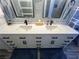 Close-up of double vanity with white countertop, black faucets, and modern black hardware at 3031 Pebble Beach Ave, Pahrump, NV 89048