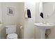 Clean half bathroom featuring a pedestal sink, and neutral walls, ideal for guests or as a convenient powder room at 3088 Evening Mist Ave, Henderson, NV 89052