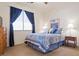 Comfortable bedroom featuring a large window, carpeted floors, and soft lighting, creating a warm and inviting ambiance at 3088 Evening Mist Ave, Henderson, NV 89052