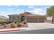 Charming single-story home with a three-car garage and desert landscaping under a blue sky at 3088 Evening Mist Ave, Henderson, NV 89052